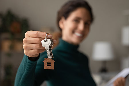 person holding the key to an apartment they just bought